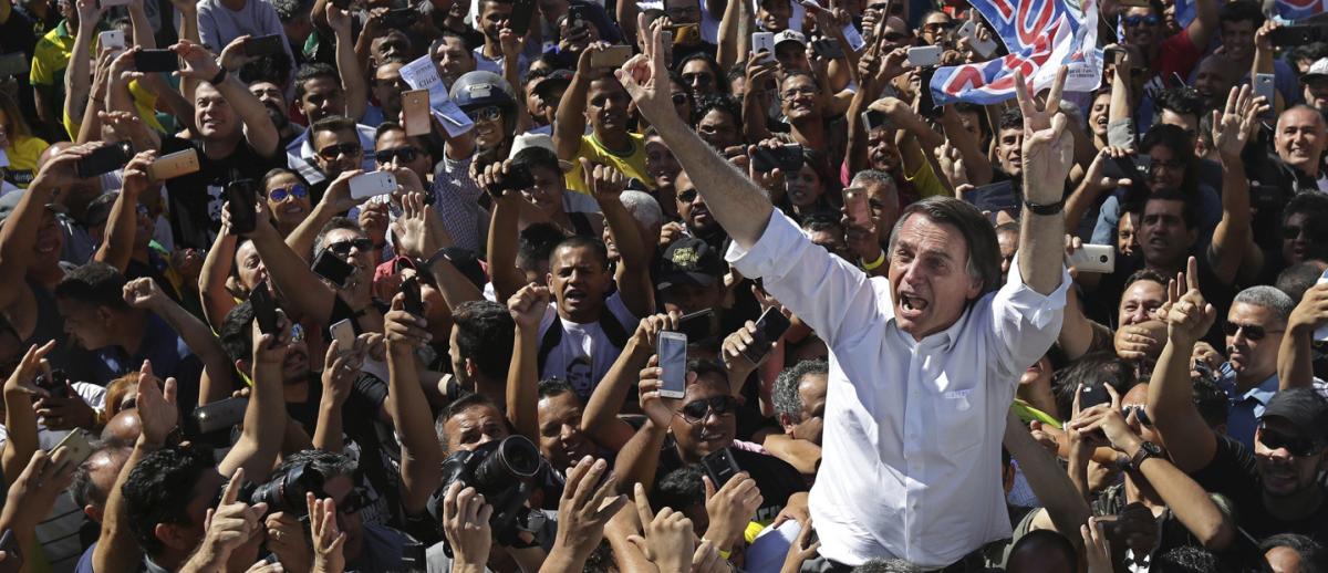 Brazilian Presidential candidate Jair Bolsonaro held aloft by cheering crowd of supporters