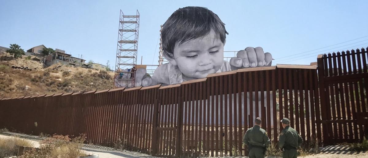 installation by French artist JR peers over the U.S.-Mexico border at Tecate, California