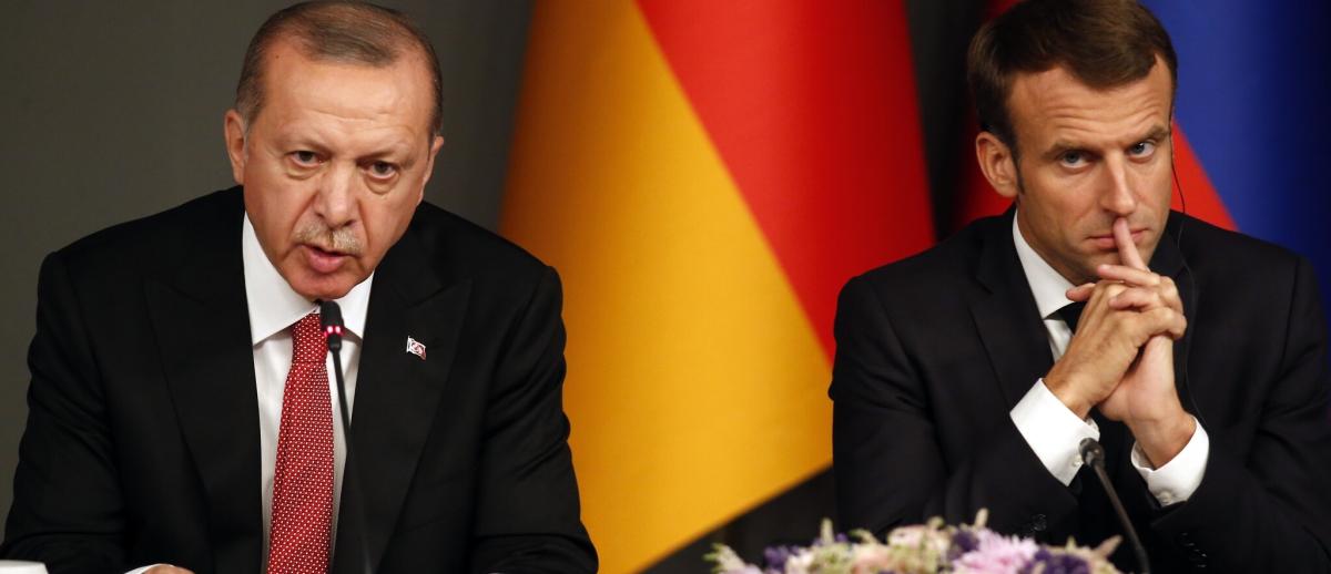Erdogan sits by Macron during a news conference 2018