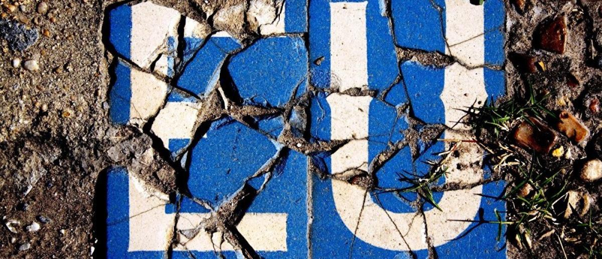 cracked blue and white tiles spelling 'EU'