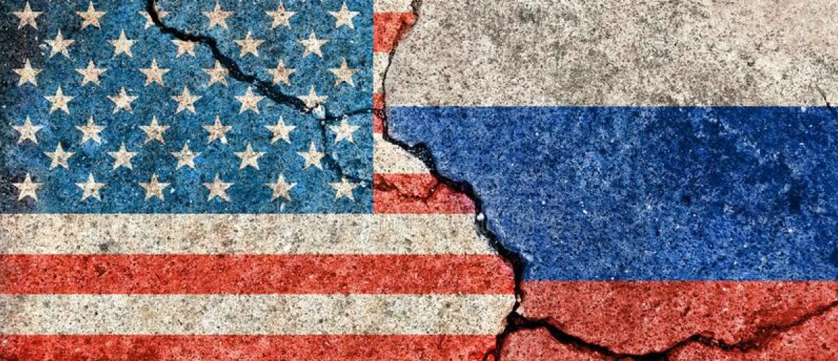 US and Russia flags painted on cracked concrete 