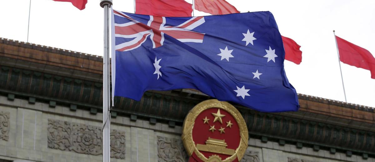 Australian flag waves in front of the Great Hall of the People in Beijing, China