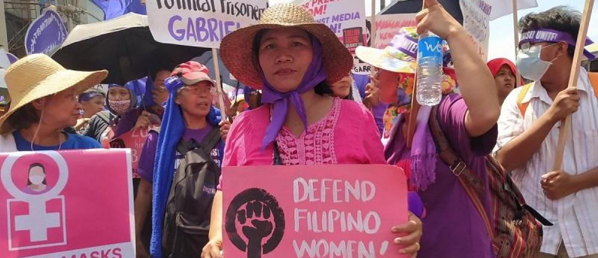 Women protest holding 'Gabriela' placards demanding defense of women's rights in the Philippines