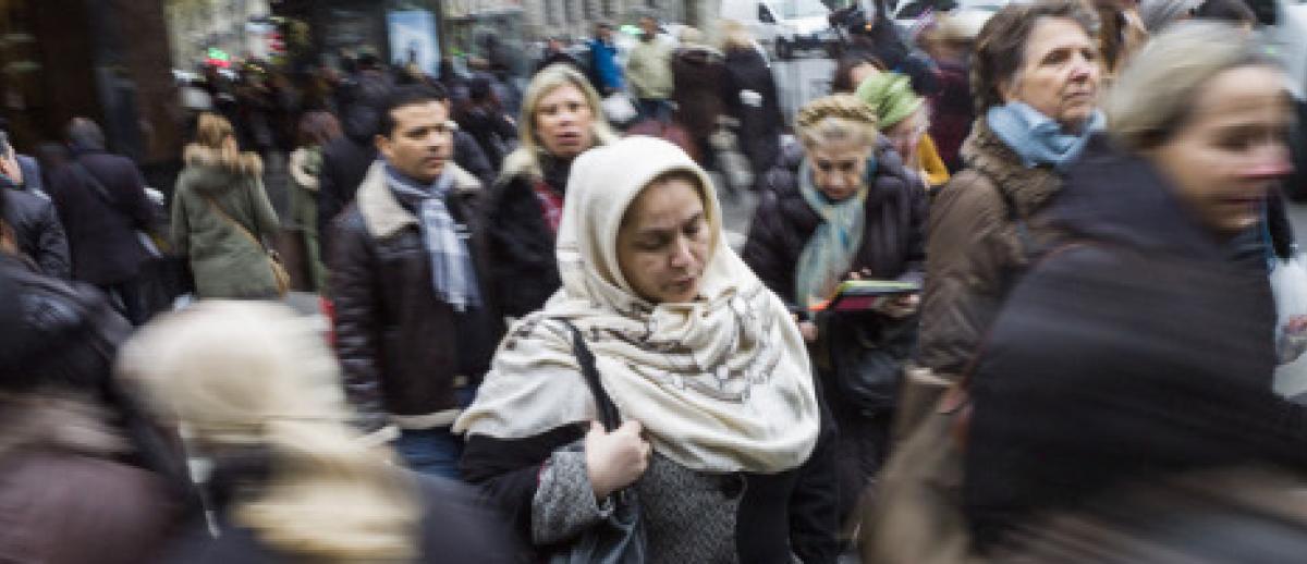 woman wearing headscarf on crowded street in France