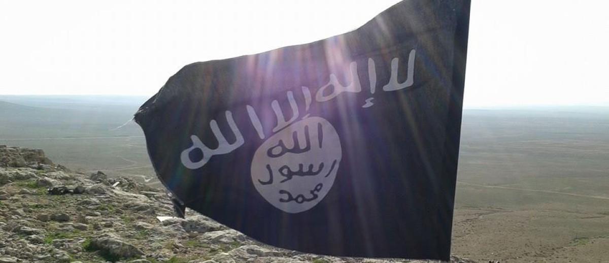 ISIS flag flies over desert landscape