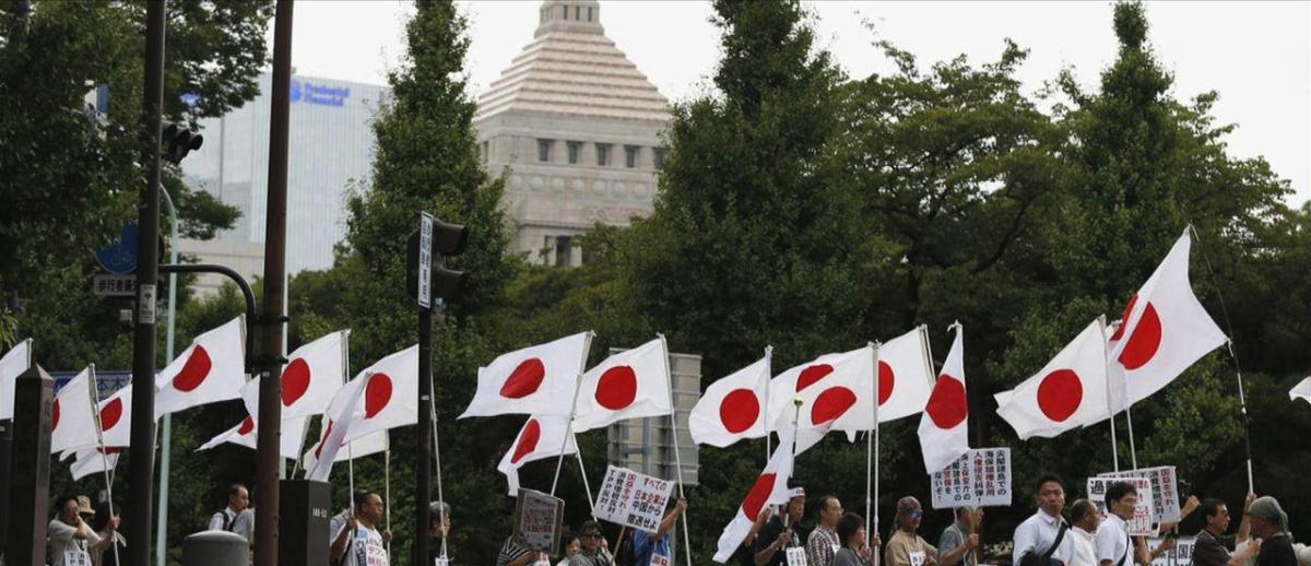 flag-beaering marchers outside the Japanese parliamentary Diet building in Tokyo