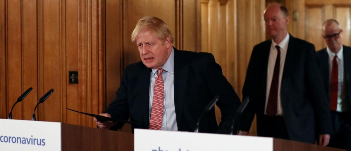 UK Prime Minister Boris Johnson approaches a podium for a coronavirus press conference