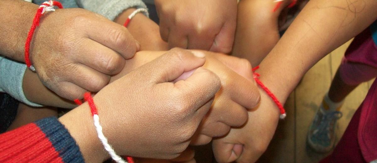 closeup of children and student hands together