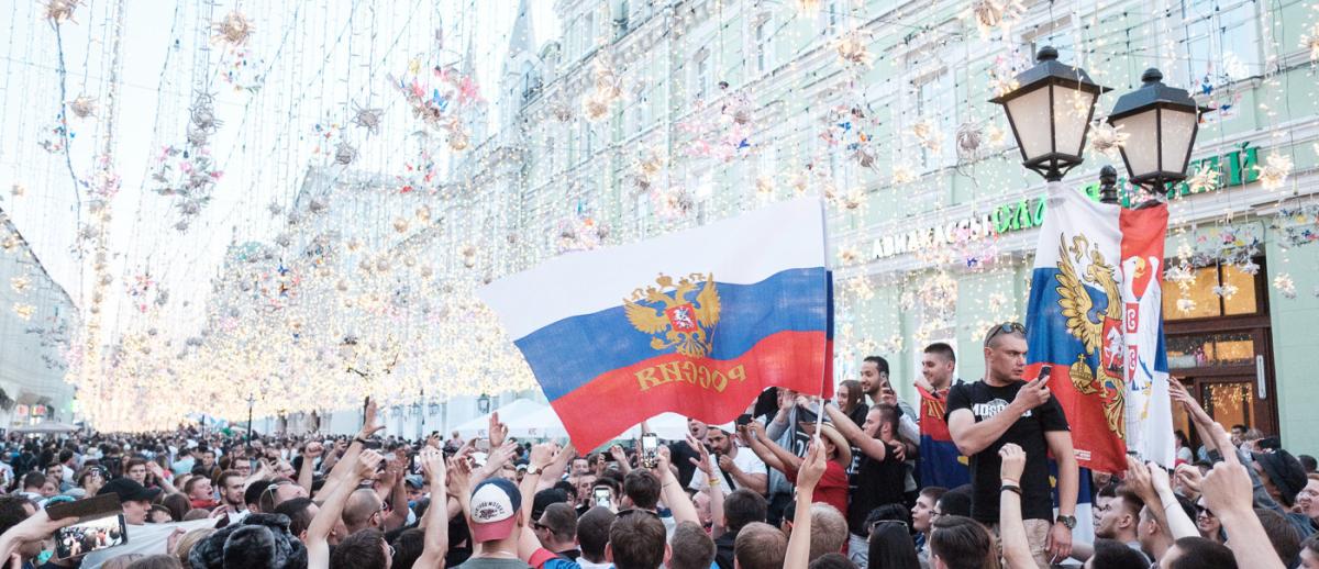 crowds of fans hoist Russian flag in Central Moscow during the 2018 FIFA World Cup