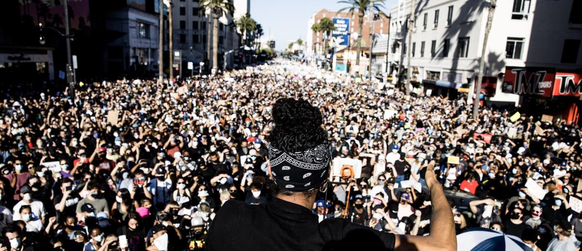 a protestor addresses a massive crowd on Hollywood Boulevard on June 7, 2020 in response to the police murder of George Floyd.