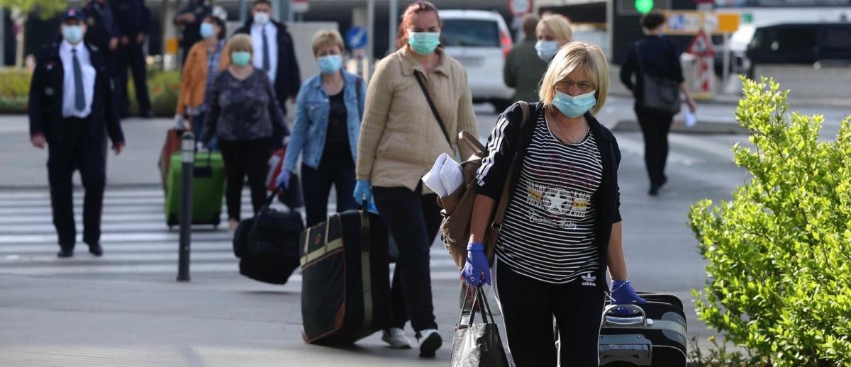 Romanian care workers accompanied by police and security at Vienna's airport in May, 2020.