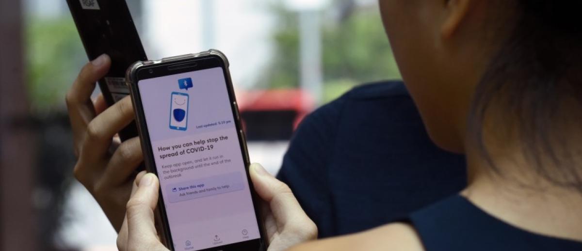 Demonstrating the contact tracing app "TraceTogether" in Singapore in March 20, 2020.  (Photo credit: The Straights Times)