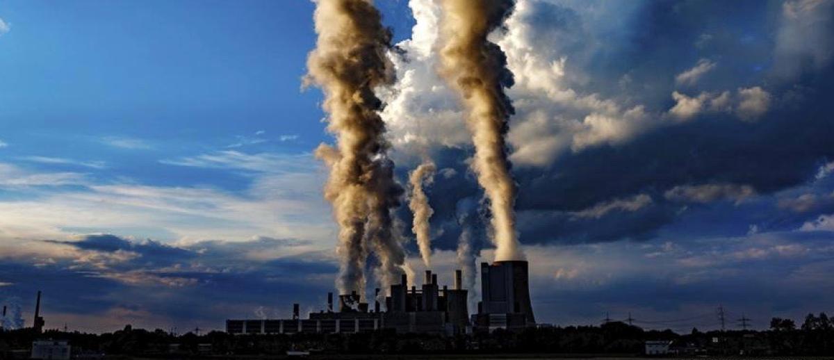 electrical power plant smokestacks belch out plumes of smoke