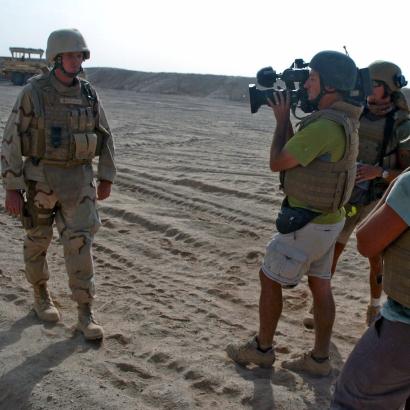 journalist filming a soldier