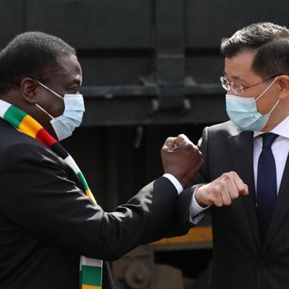 Zimbabwean President Emmerson Mnangagwa (L) and Chinese ambassador to Zimbabwe Guo Shaochun elbow bump