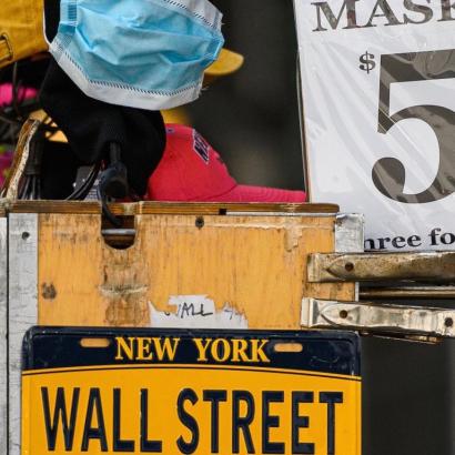 a New York street vendor cart advertising masks for $5.00, beneath it a New York license plate reading 'Wall Street'