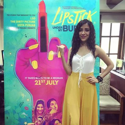 woman stands next to large marketing poster for the film 'Lipstick Under My Burkha' (Source: the author)