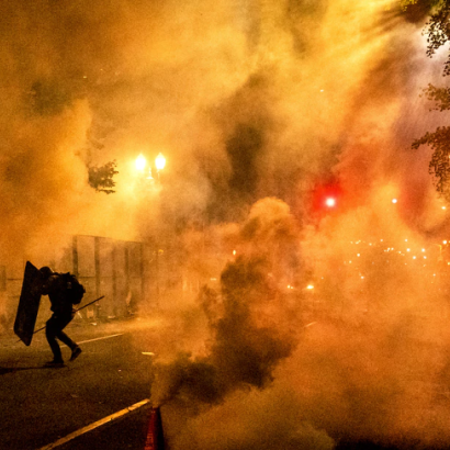 2020 Black Lives Matter protester silhouetted by smoke and tear gas in Portland, Oregon
