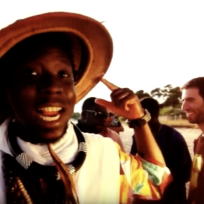 screenshot of video for the song 'Satati' by Momar Gaye and band Zaman, on beach in Sardinia