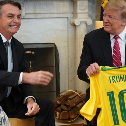 Brazilian President Jair Bolsonaro and President Trump exchange soccer jerseys bearing each other's names in the Oval Office, March 2019