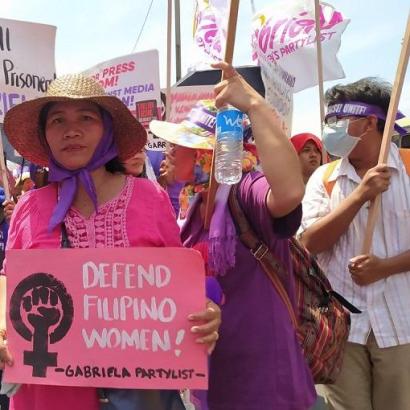 Women protest holding 'Gabriela' placards demanding defense of women's rights in the Philippines