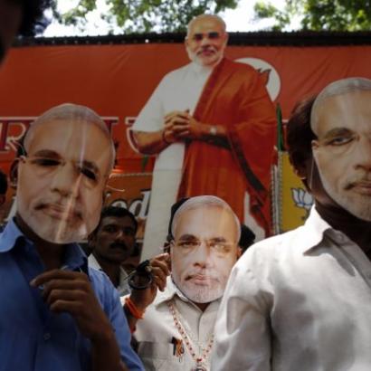 Indian voters at 2014 rally wear masks of the face of Narendra Modi