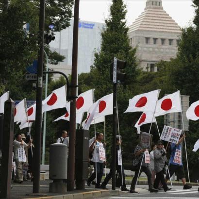 flag-beaering marchers outside the Japanese parliamentary Diet building in Tokyo