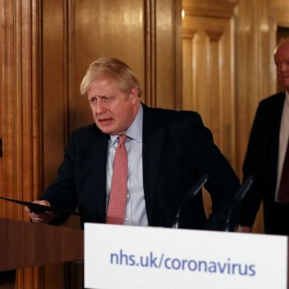 UK Prime Minister Boris Johnson approaches a podium for a coronavirus press conference