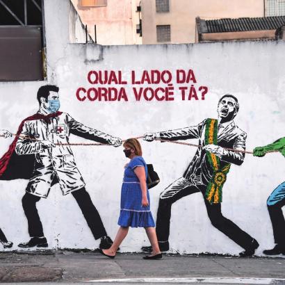 mural in Sao Paolo, Brazil depicts a tug of war between masked medical workers on one side, and on the other Brazilian President Jair Bolsonaro with a personified COVID-19 virus