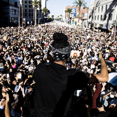 a protestor addresses a massive crowd on Hollywood Boulevard on June 7, 2020 in response to the police murder of George Floyd.
