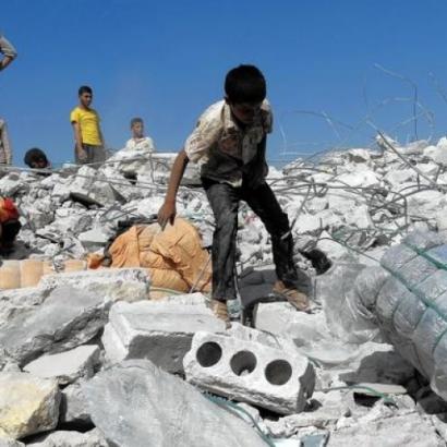 children climbing upon the rubble of U.S.-led coalition airstrike in Kafar Daryan in Syria. (Photo: Getty Images)