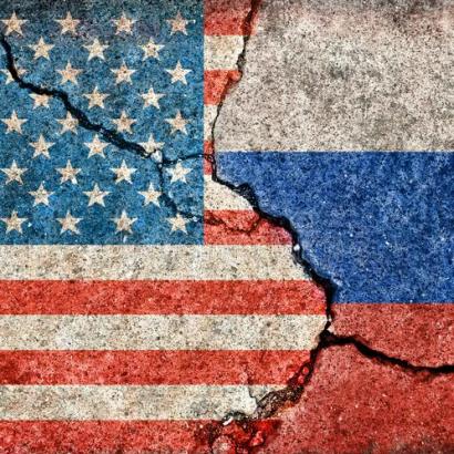US and Russia flags painted on cracked concrete