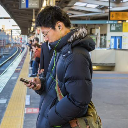 cellphone user on train platform