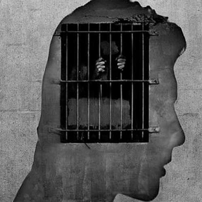 wall mural of a head in silhouette over a barred window
